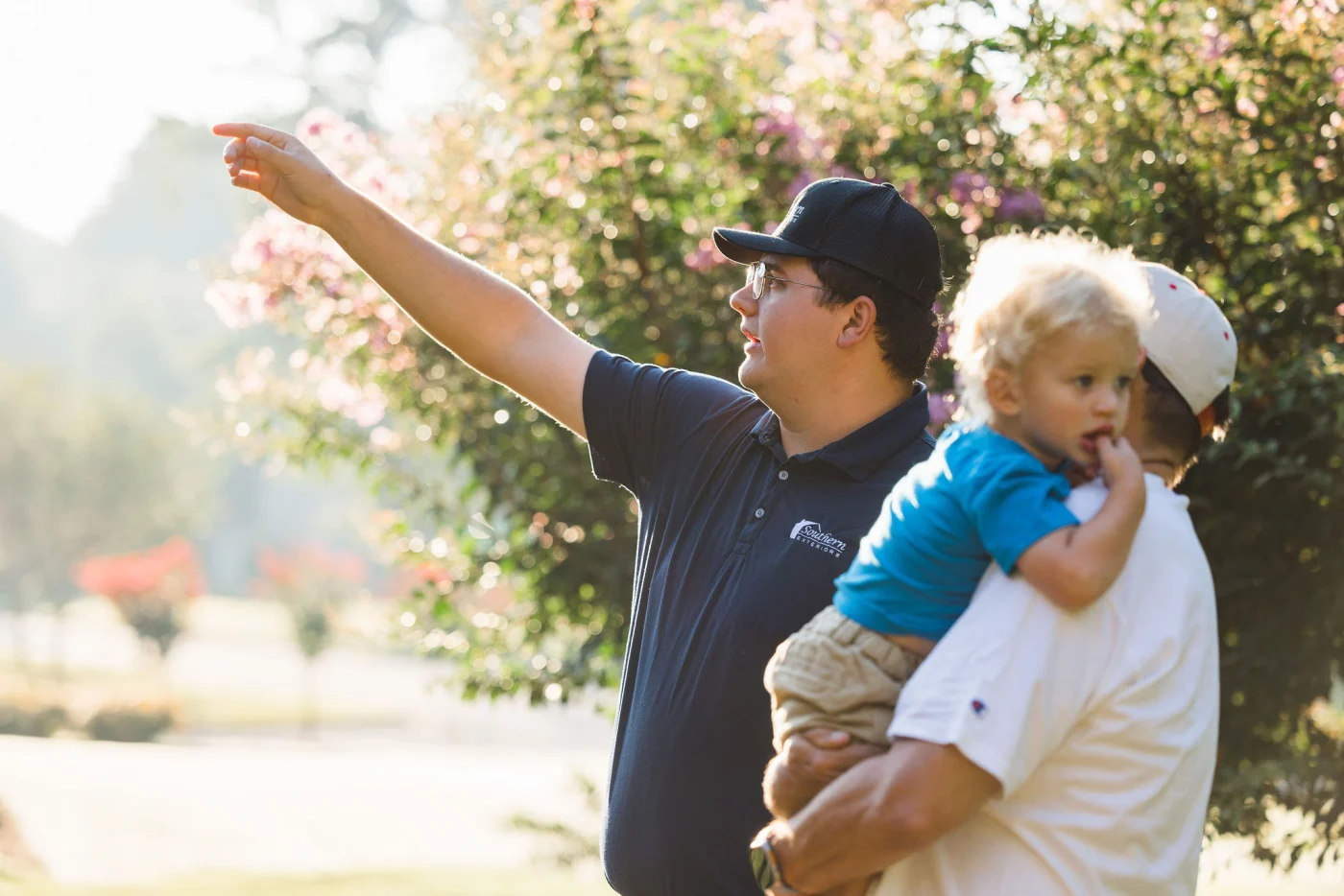 A Southern Exteriors team member discussing home improvements with a family. A Southern Exteriors team member discussing home improvements with a family.