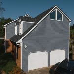 A two-story home with blue-gray siding and white trim